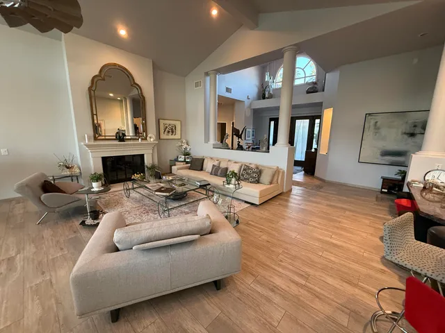 a view of a dining room with furniture a chandelier and wooden floor