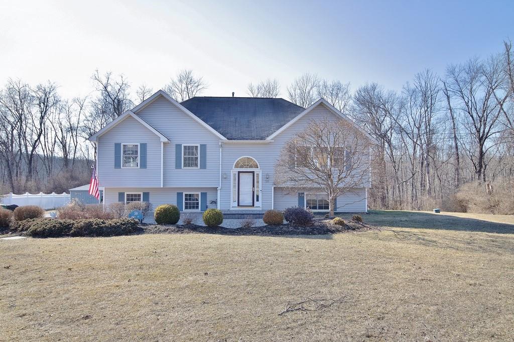 a front view of house with yard and trees around