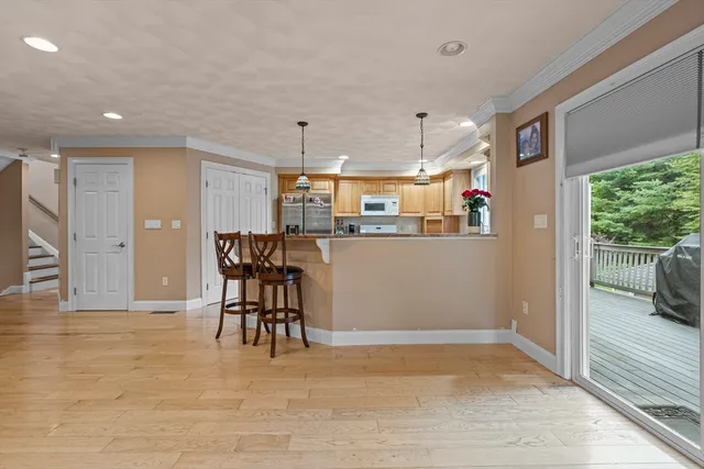 a view of a kitchen with a dining table chairs and entryway