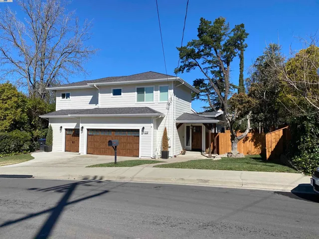 a front view of a house with a yard and a garage