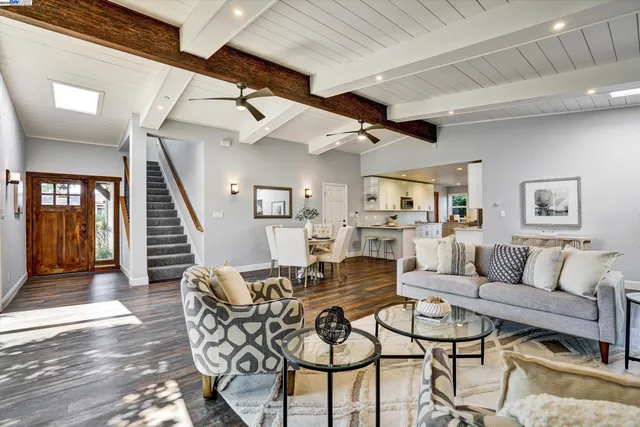 a kitchen with granite countertop white cabinets and white appliances