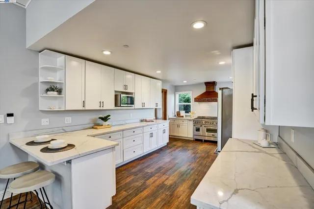 a spacious bathroom with a double vanity sink a mirror and a bathtub