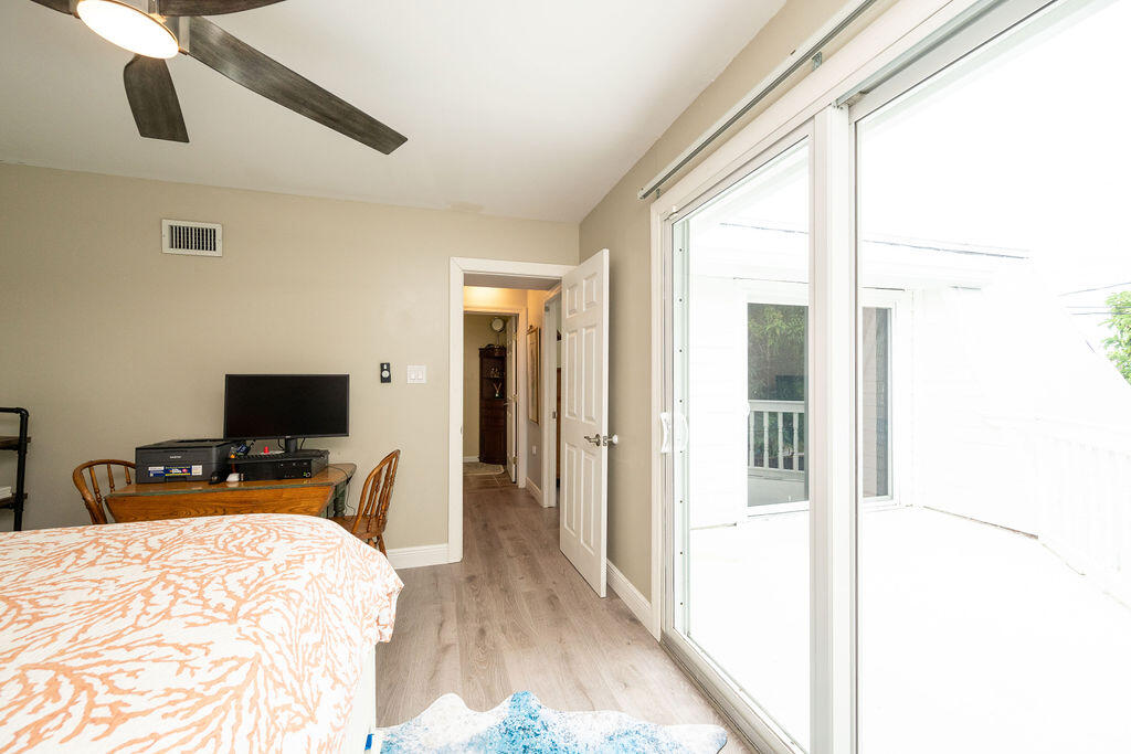 3246 Duck Avenue Key West, FL 33040 - Photo 13 of 21 a bedroom with a bed and wooden floor