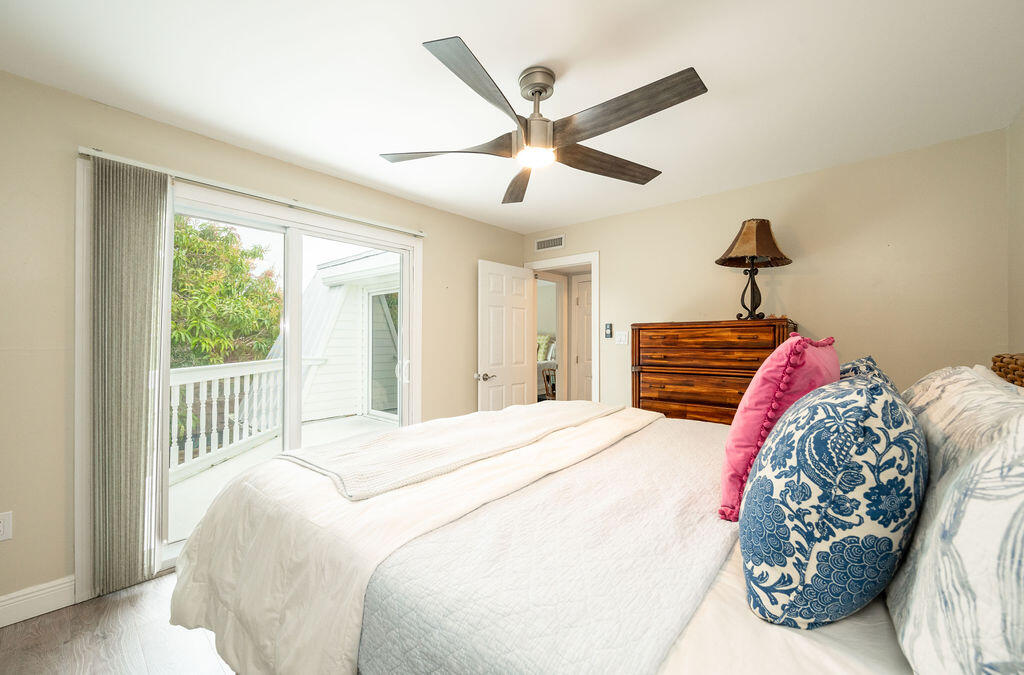 3246 Duck Avenue Key West, FL 33040 - Photo 21 of 21 a bedroom with a large bed and a chandelier
