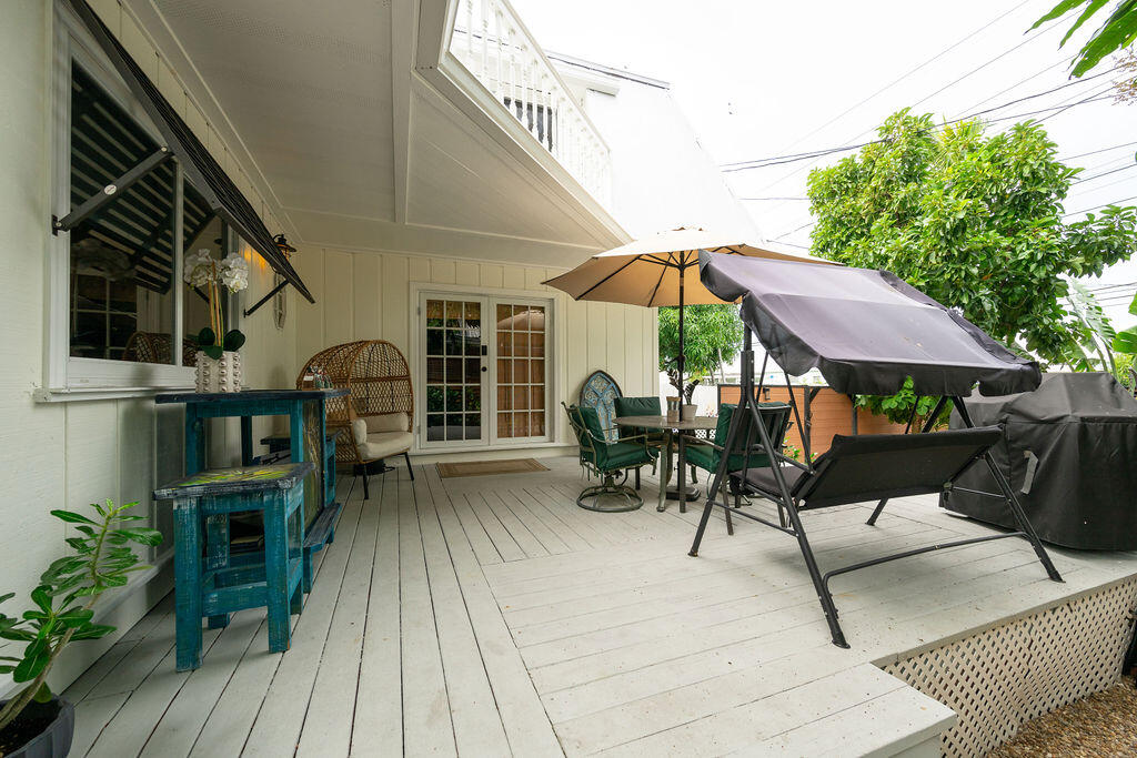 3246 Duck Avenue Key West, FL 33040 - Photo 4 of 21 a view of a patio with table and chairs under an umbrella with wooden floor