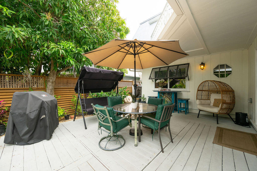 3246 Duck Avenue Key West, FL 33040 - Photo 7 of 21 a view of deck with table and chairs under an umbrella