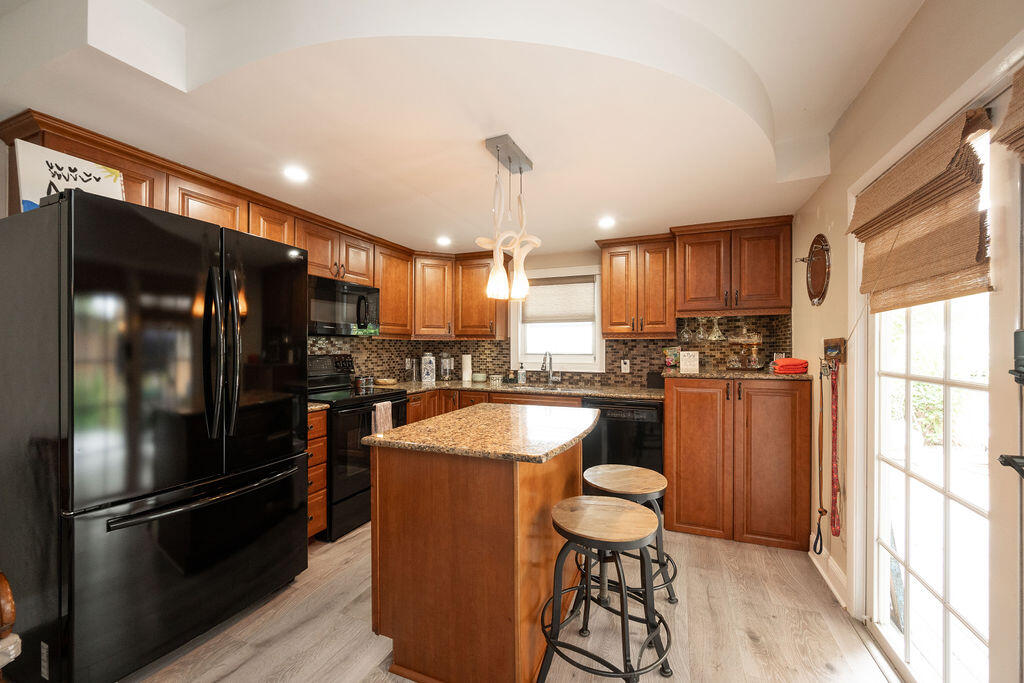 3246 Duck Avenue Key West, FL 33040 - Photo 8 of 21 a kitchen with stainless steel appliances granite countertop a refrigerator a sink a stove and a window