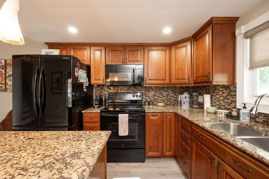 3246 Duck Avenue Key West, FL 33040 - Photo 9 of 21 a kitchen with stainless steel appliances granite countertop a refrigerator and a sink