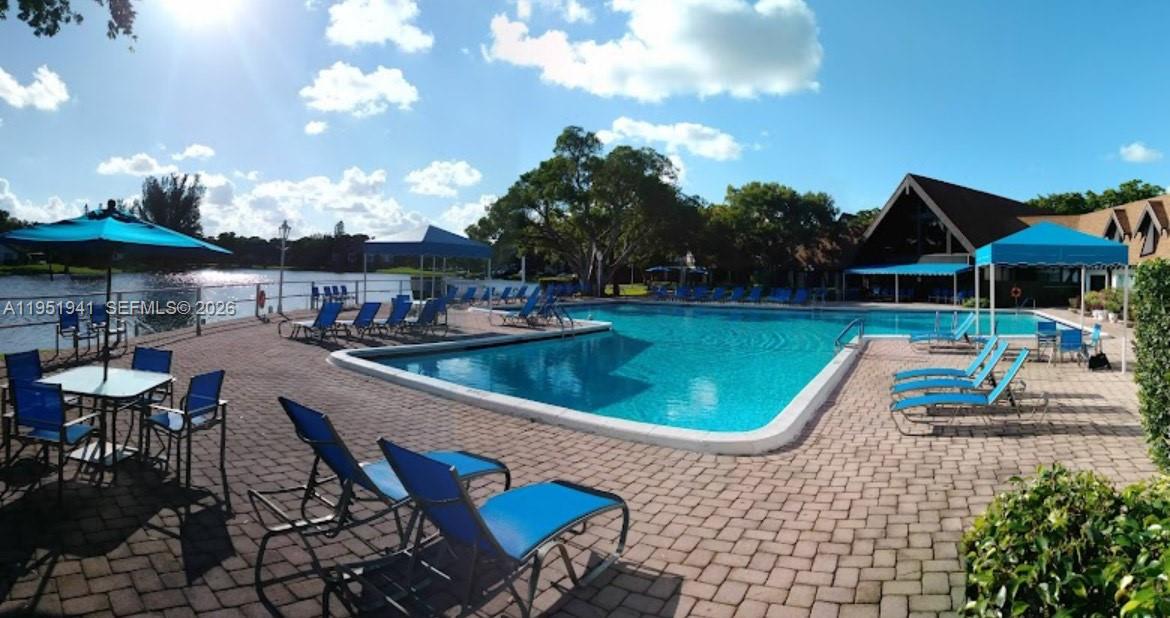 3670 Inverrary Drive, Unit 1K Lauderhill, FL 33319 - Photo 11 of 13 an outdoor space with furniture and umbrella