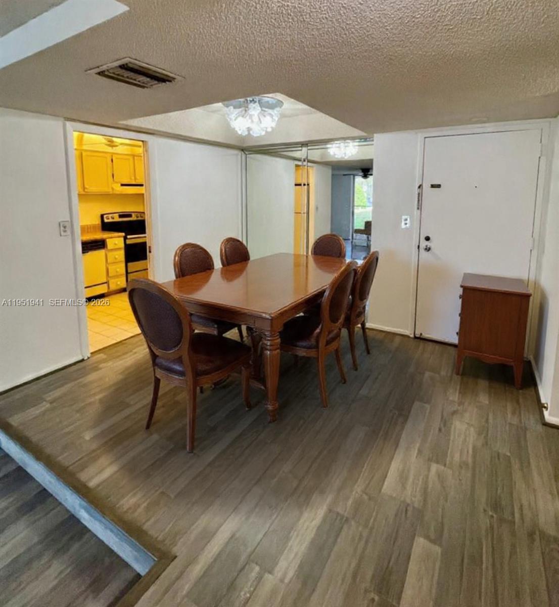 3670 Inverrary Drive, Unit 1K Lauderhill, FL 33319 - Photo 2 of 13 a view of a dining room with furniture and wooden floor