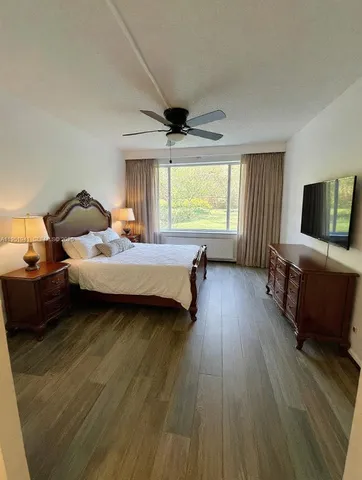 a spacious bedroom with a bed and a large window