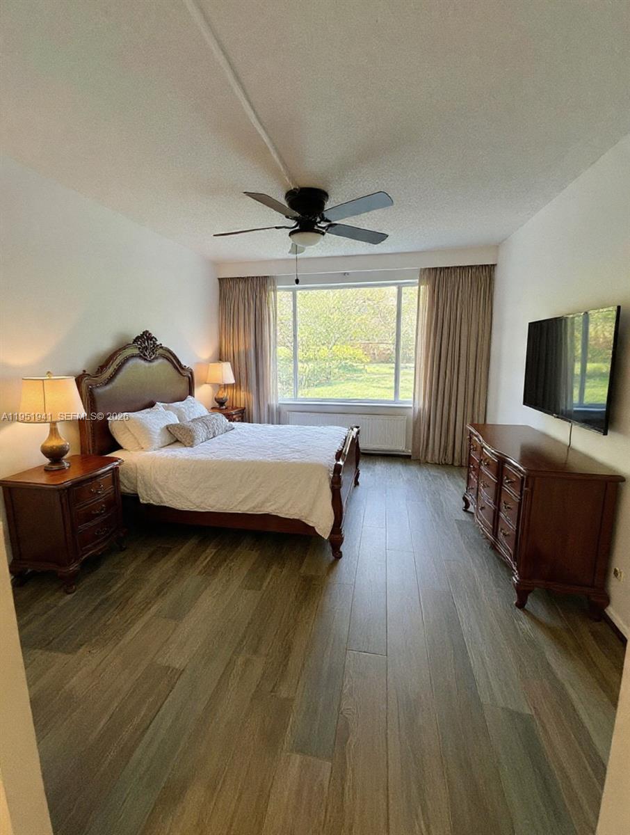 3670 Inverrary Drive, Unit 1K Lauderhill, FL 33319 - Photo 3 of 13 a spacious bedroom with a bed and a large window