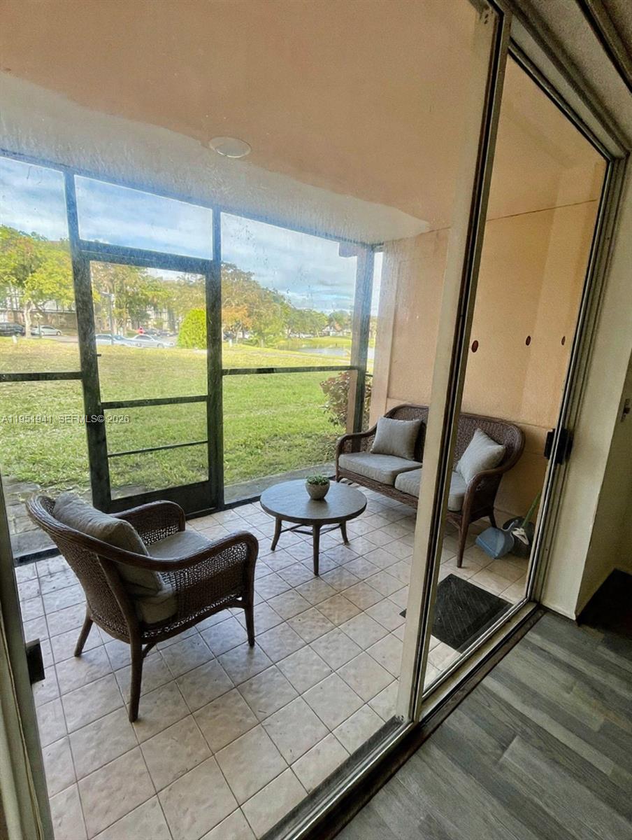 3670 Inverrary Drive, Unit 1K Lauderhill, FL 33319 - Photo 4 of 13 a living room with furniture and a large window