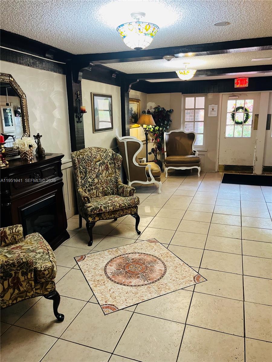 3670 Inverrary Drive, Unit 1K Lauderhill, FL 33319 - Photo 9 of 13 a bedroom with furniture and a mirror