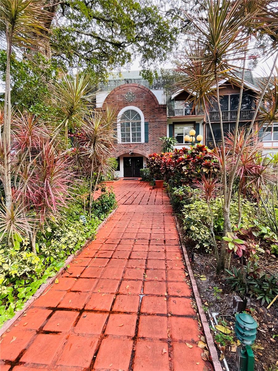 3670 Inverrary Drive, Unit 1K Lauderhill, FL 33319 - Photo 10 of 13 a front view of a house with a yard