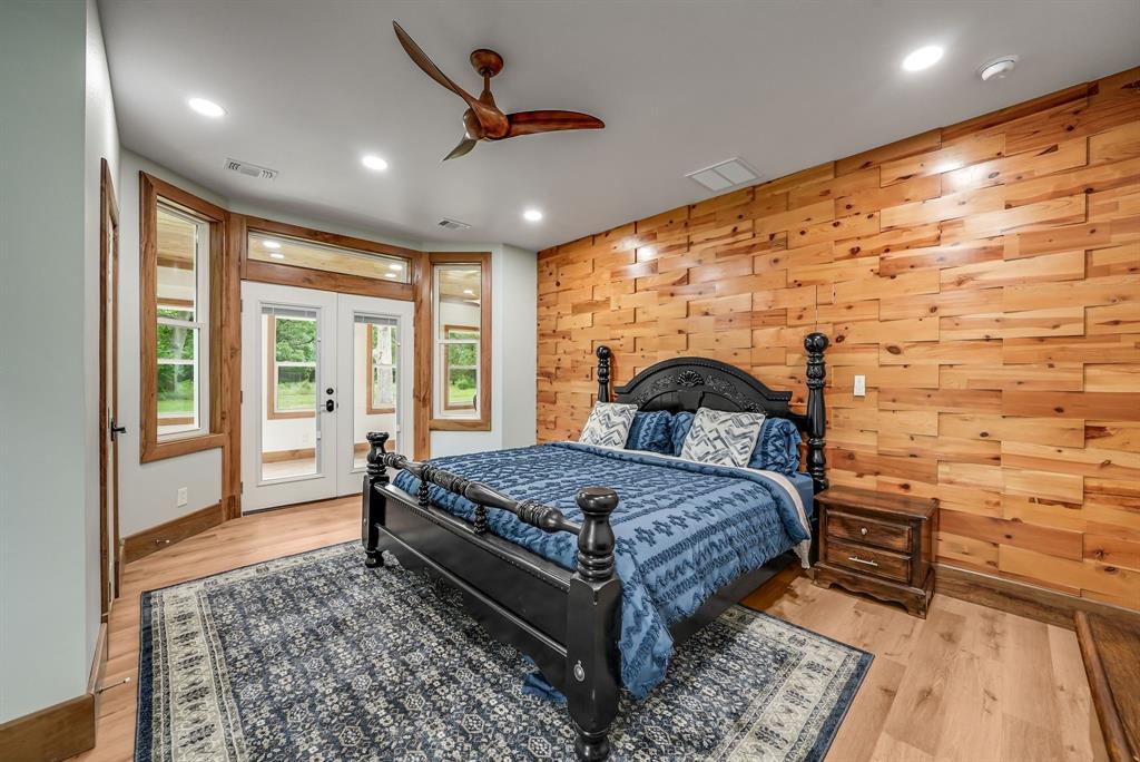 1037 Harrison Road Denison, TX 75021 - Photo 5 of 39 Accent wood-paneled wall complementing wood-finish flooring