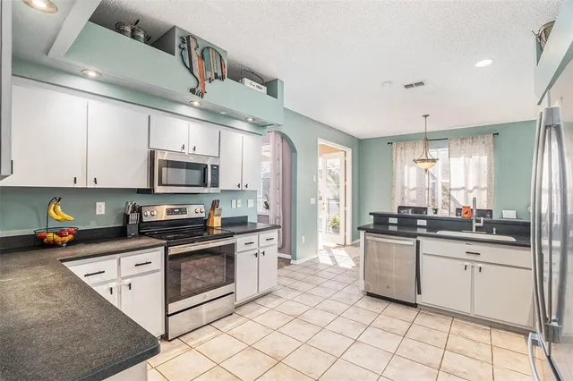 a utility room with cabinets washer and dryer