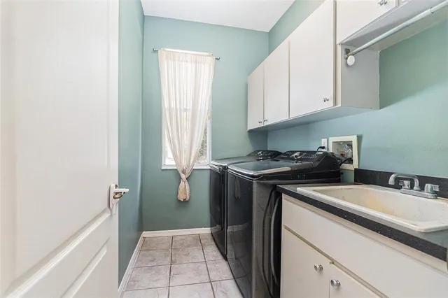 a bathroom with a granite countertop sink mirror vanity and toilet