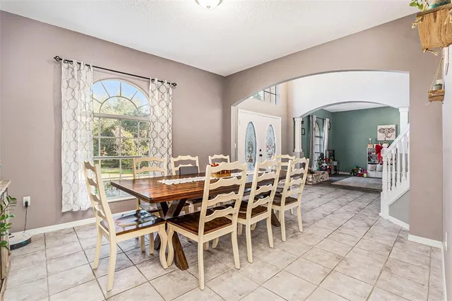 a dining room with furniture and window