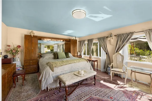 a spacious bedroom with a bed and a large window