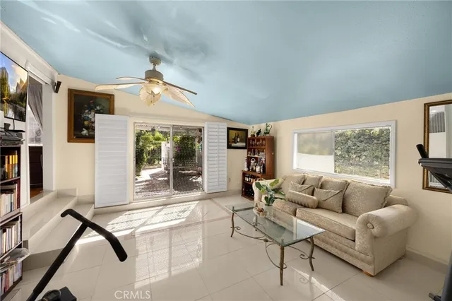 a living room with furniture a window and a flat screen tv