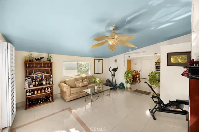 a bedroom with furniture and a large window