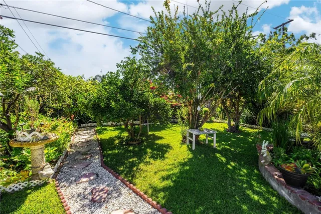 a view of a house with backyard sitting area and garden