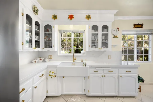 a kitchen with a sink dishwasher and cabinets
