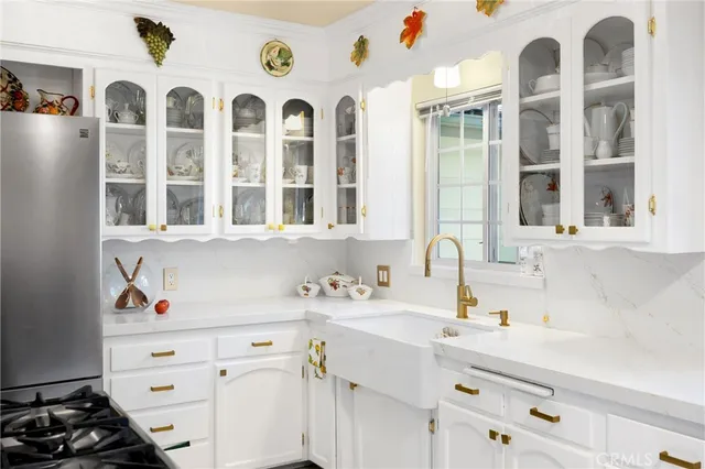 a kitchen with stainless steel appliances a stove a sink and a refrigerator