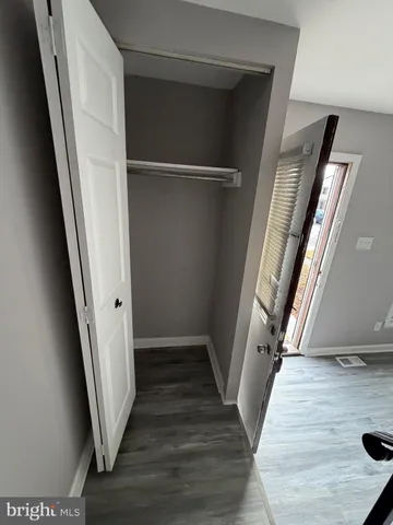 a view of a hallway view of wooden floor and staircase