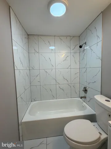 a bathroom with a toilet and bathtub