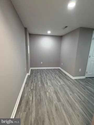 a view of room with wooden floor