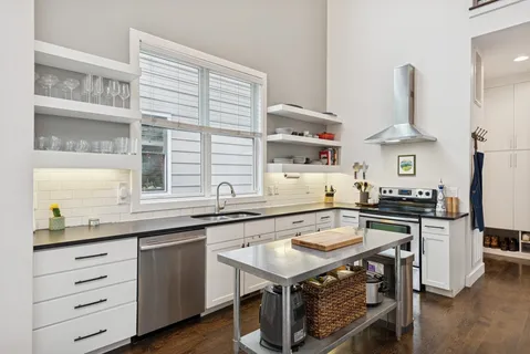 a kitchen with granite countertop a sink appliances and cabinets
