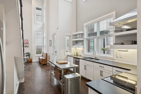 a kitchen with a sink and stove top oven