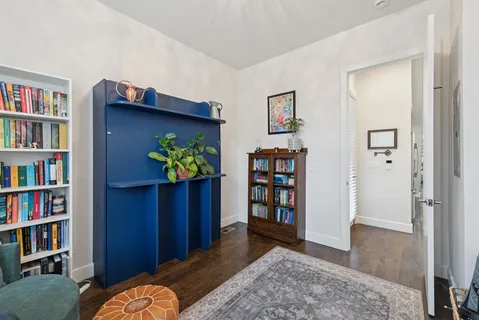 a view of a livingroom with a book shelf