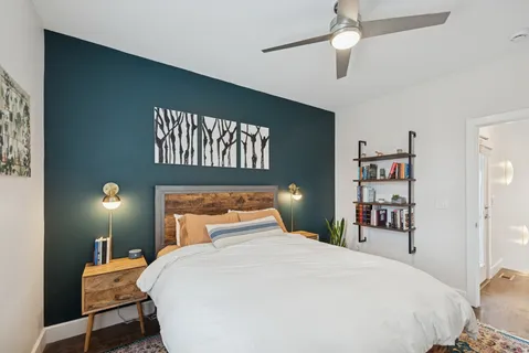 a bedroom with a bed and a chandelier