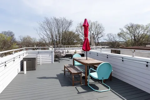 a view of a chairs and table on the wooden deck