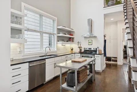 a kitchen with a sink stove and cabinets