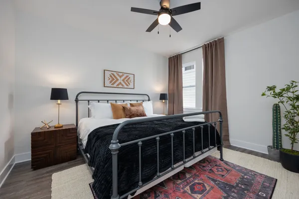 a bedroom with a bed and wooden floor
