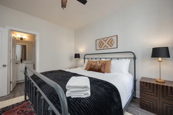 a bedroom with a bed and wooden floor