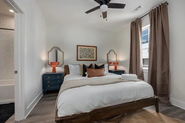 a bedroom with bed and a chandelier
