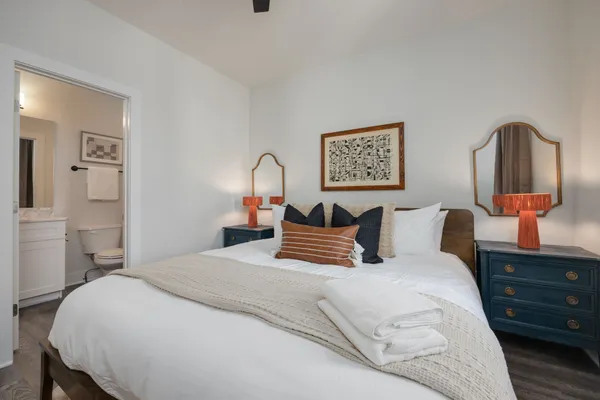 a bedroom with a bed and wooden floor