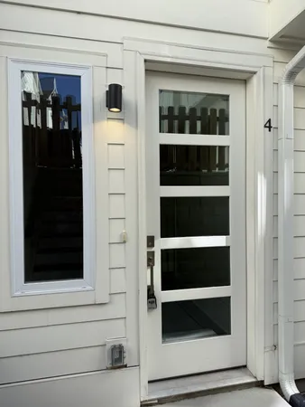 a view of walk in closet with wooden floor and a window