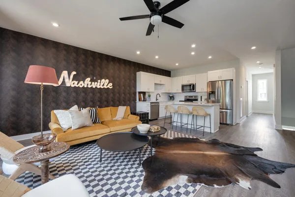 a living room with furniture and kitchen view