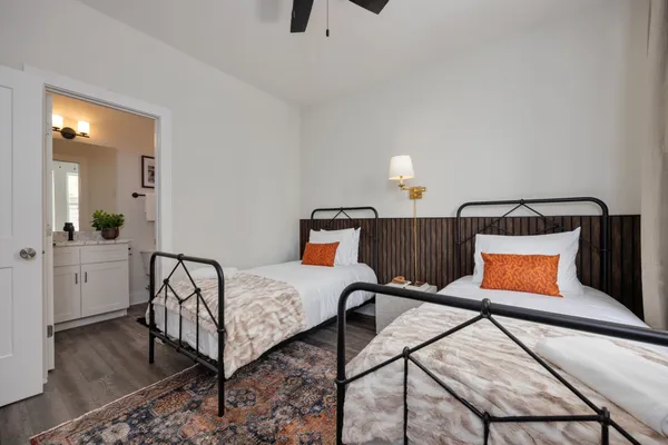 a bedroom with furniture and wooden floor