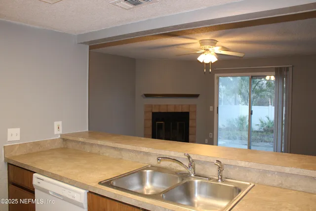 a view of kitchen with granite countertop window and sink