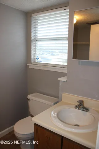 a white toilet sitting next to a bathroom sink