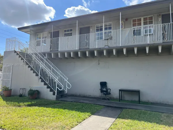 a house with lots of trees in the background