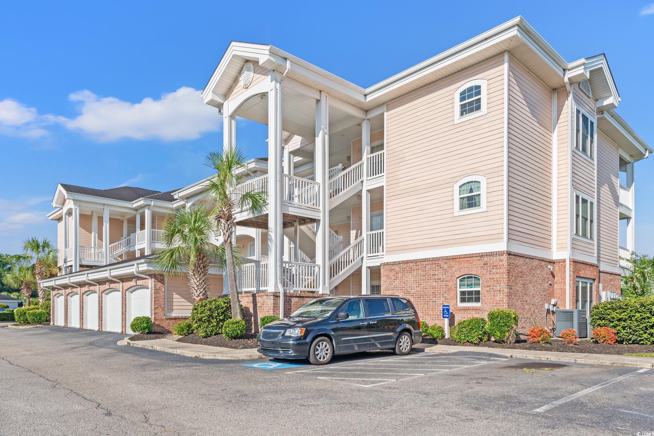 4864 Carnation Circle, Unit 304 Myrtle Beach, SC 29577 - Photo 1 of 36 View of building exterior featuring uncovered parking