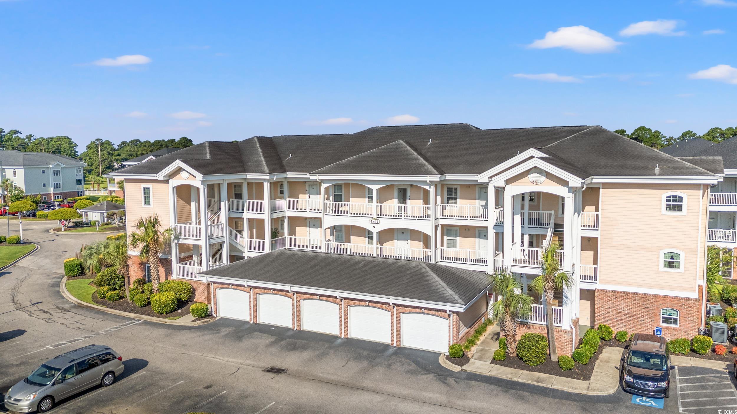 4864 Carnation Circle, Unit 304 Myrtle Beach, SC 29577 - Photo 24 of 36 View of building exterior featuring community garages